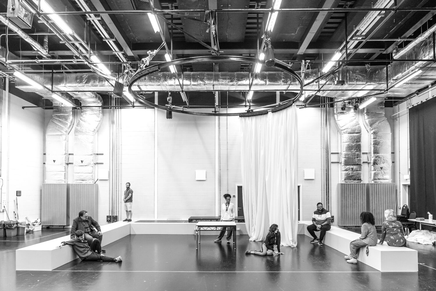 Actors rehearsing in a large studio.